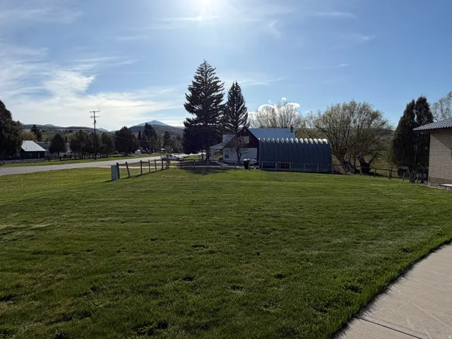 View of yard featuring a mountain view, an outdoor structure, and a barn