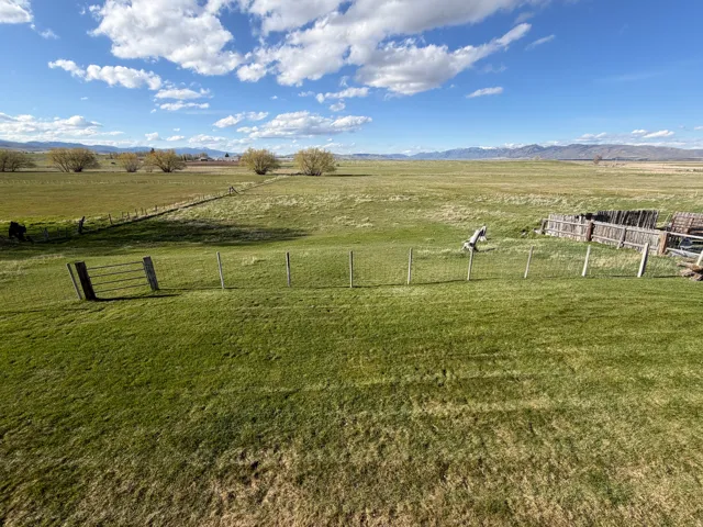 View of yard with a rural view and a mountain view