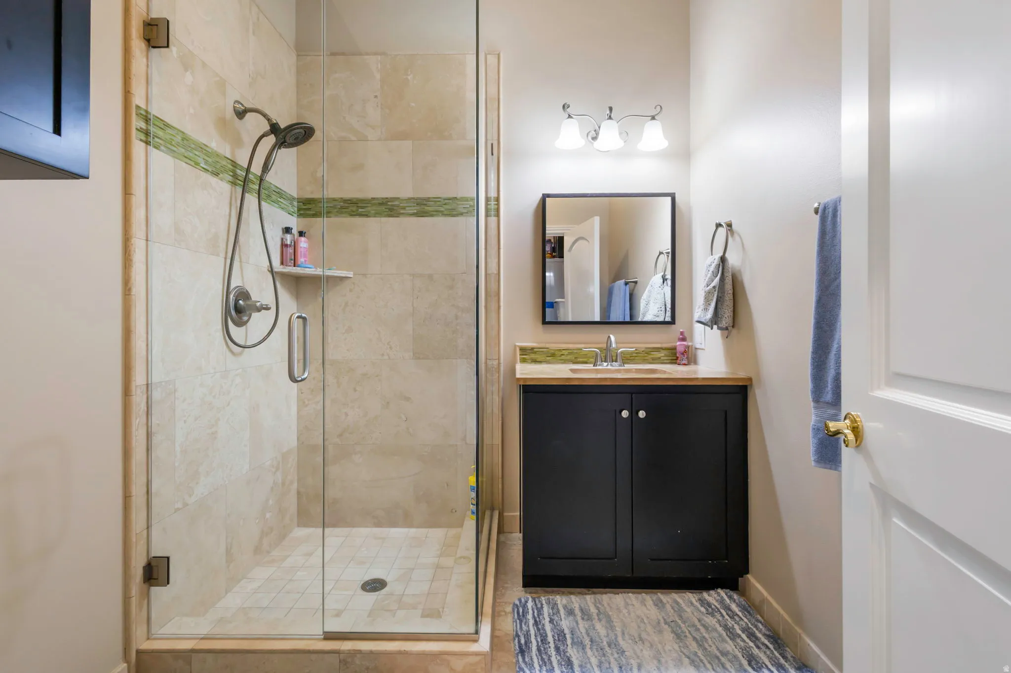 Bathroom with a stall shower and vanity