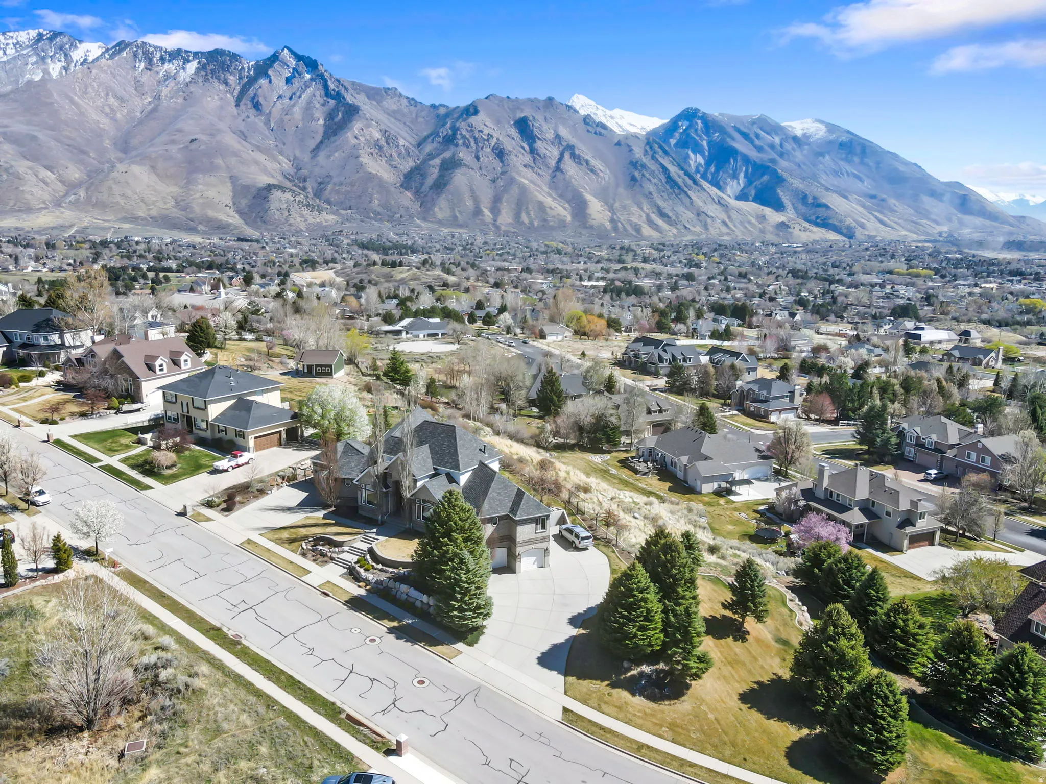 Aerial perspective of suburban area with a mountainous background