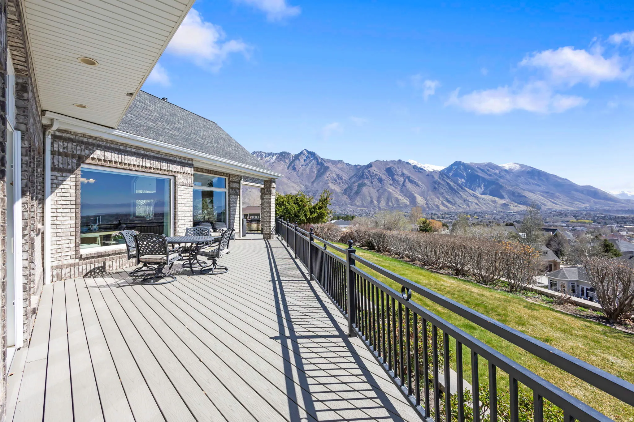 Wooden deck with a mountain view and outdoor dining area