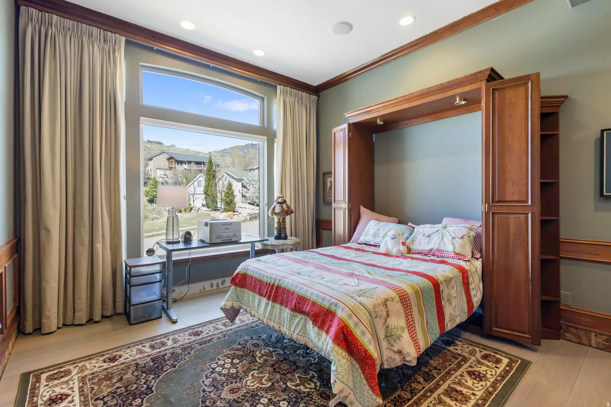 Bedroom featuring light wood-style floors, ornamental molding, and recessed lighting
