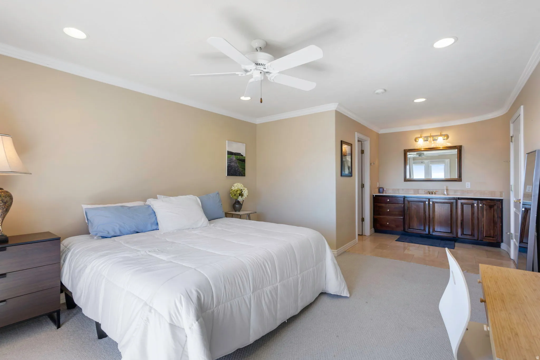 Bedroom featuring crown molding, ceiling fan, recessed lighting, light colored carpet, and stainless steel refrigerator