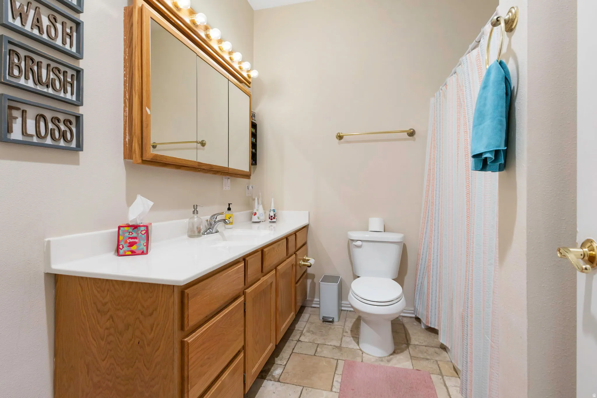 Full bath with vanity and a shower with shower curtain