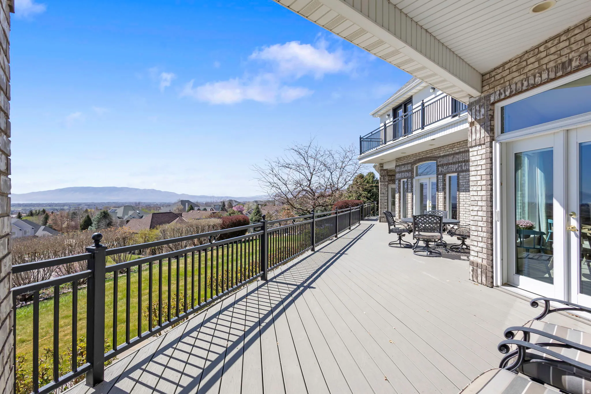 Wooden deck featuring a residential view and a yard