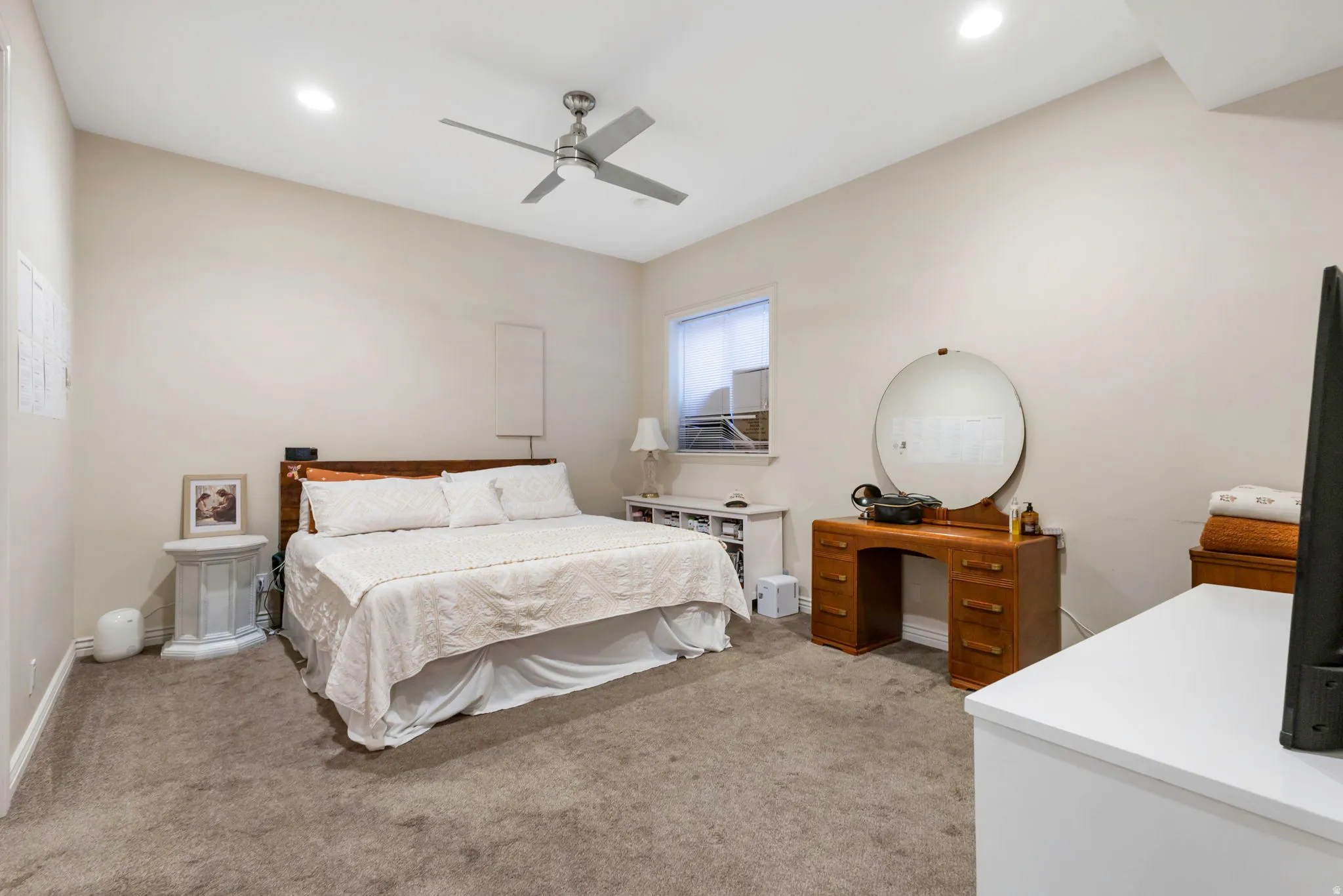 Bedroom with light carpet, a ceiling fan, and recessed lighting