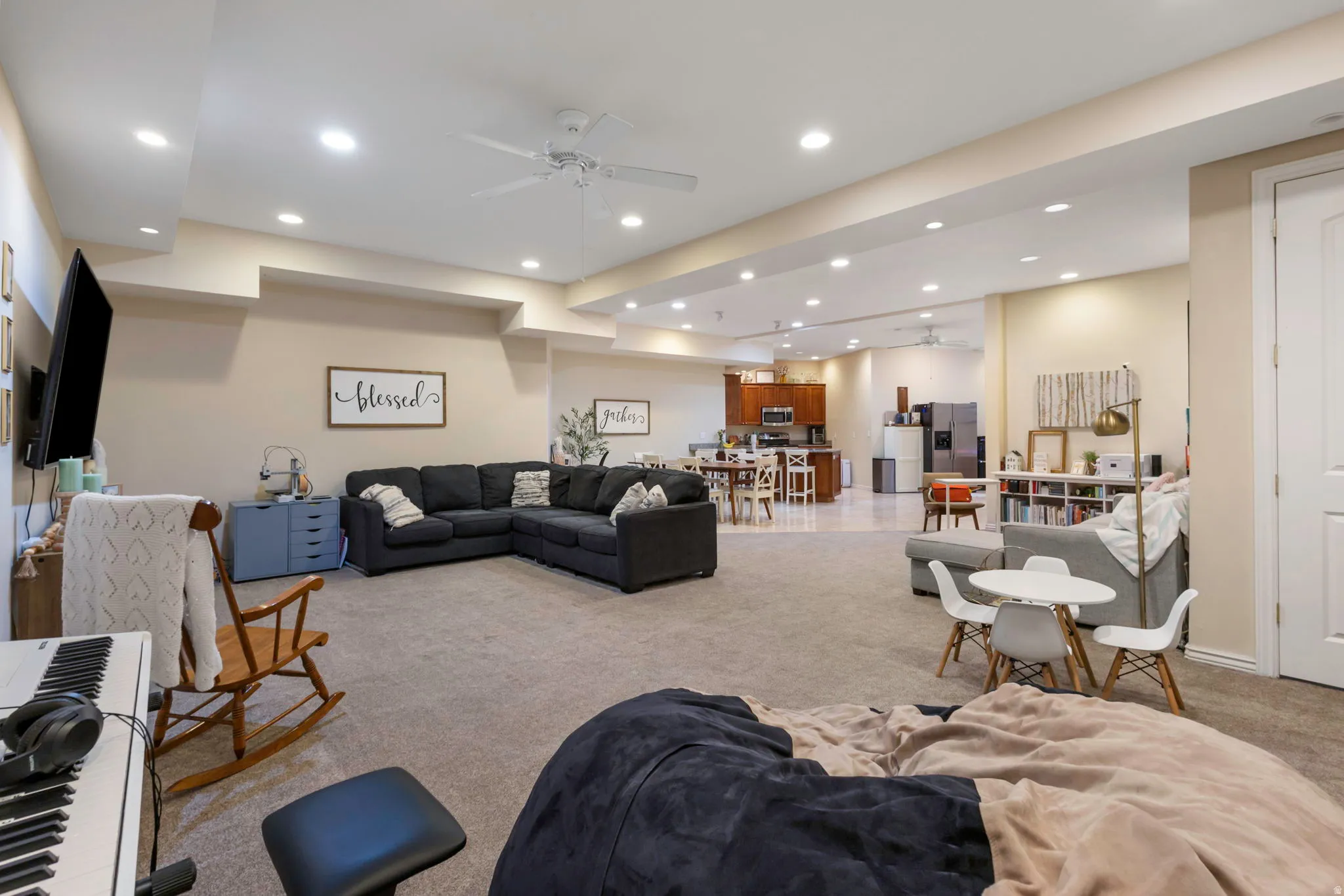 Living room with a ceiling fan, carpet flooring, and recessed lighting