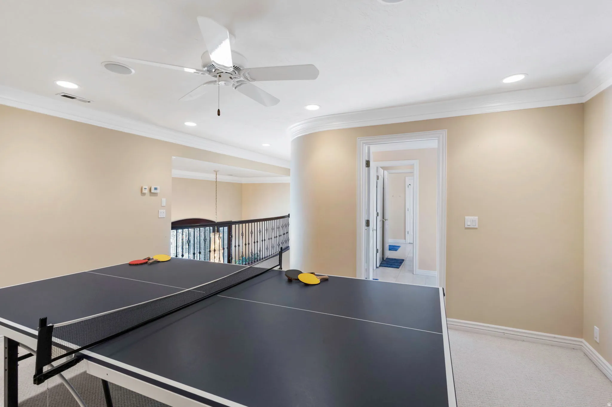 Recreation room featuring a ceiling fan, crown molding, light colored carpet, and recessed lighting