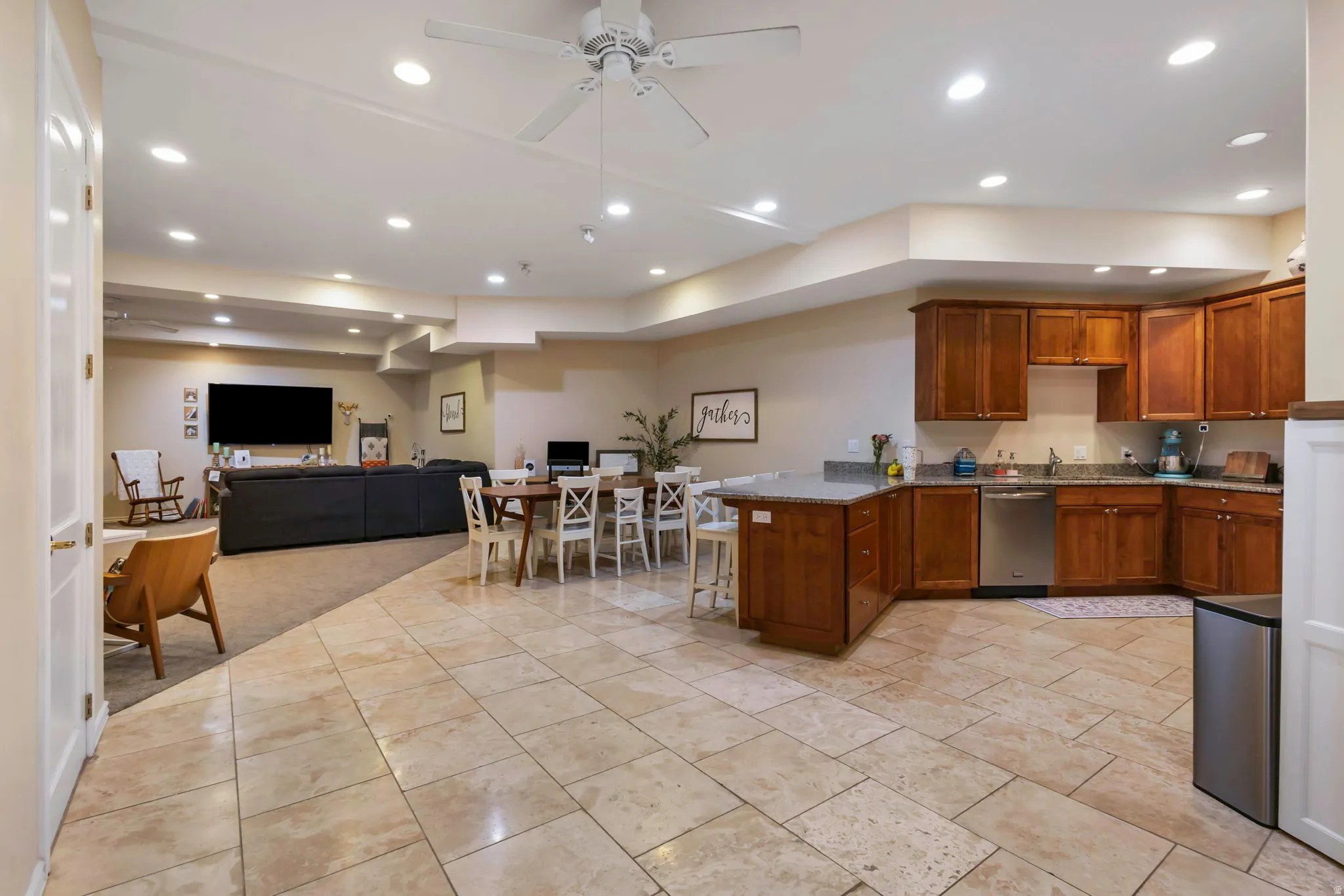 Kitchen with open floor plan, a peninsula, wood finish cabinetry, ceiling fan, and recessed lighting