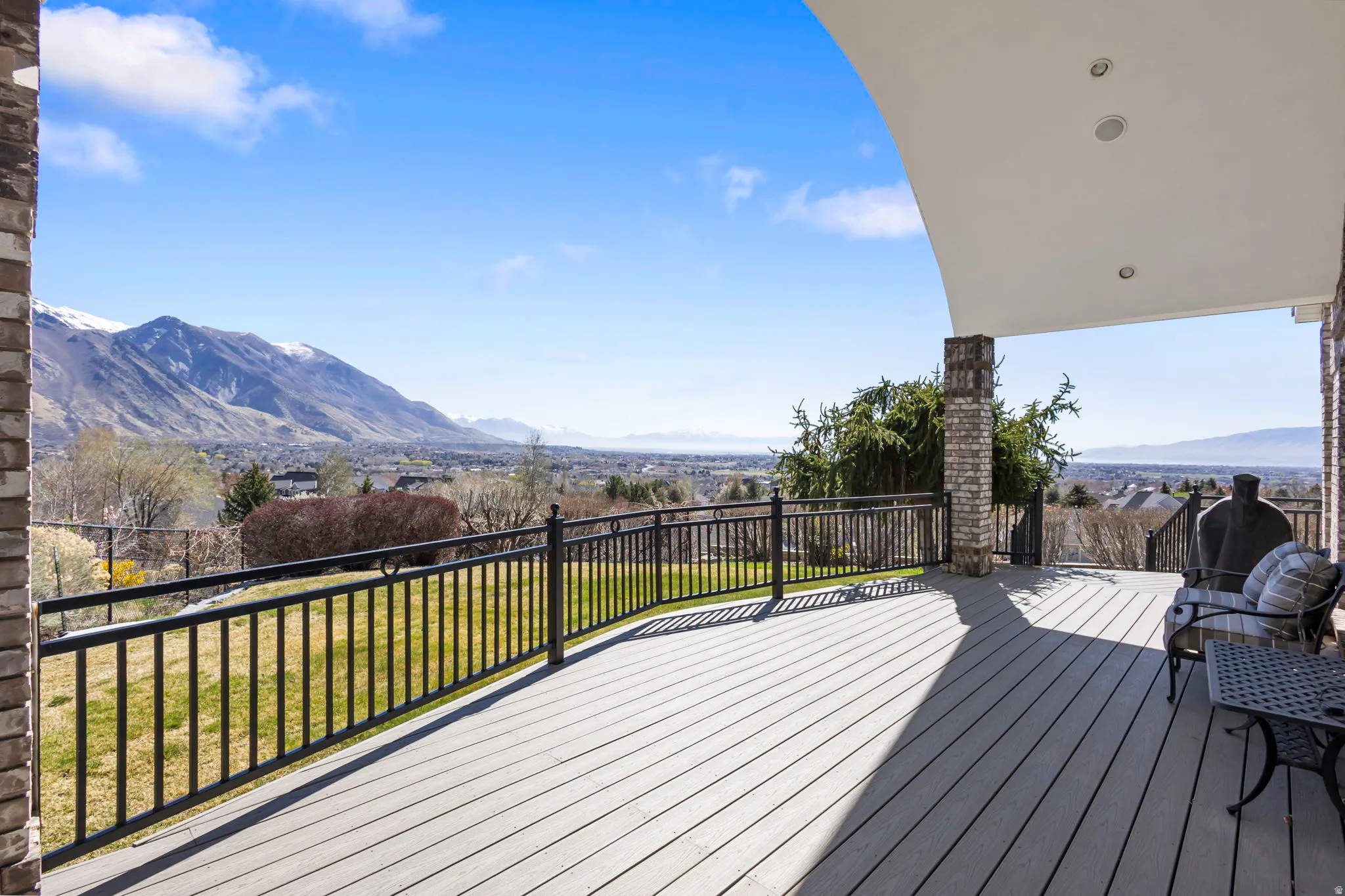 Wooden terrace featuring a yard and a mountain view