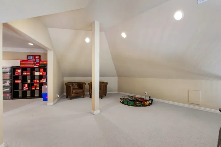 Game room featuring light colored carpet, recessed lighting, and vaulted ceiling