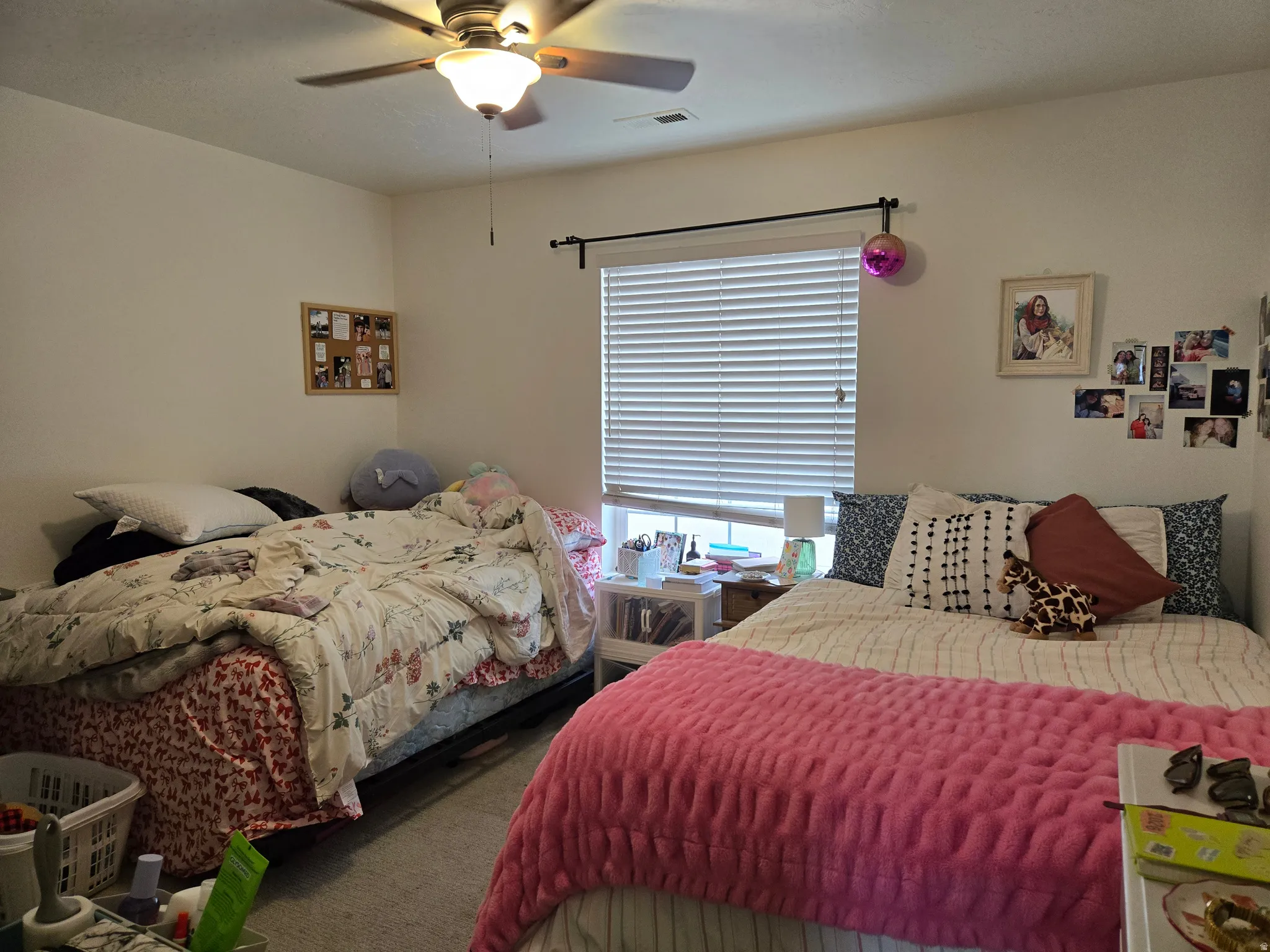 Bedroom featuring ceiling fan and carpet