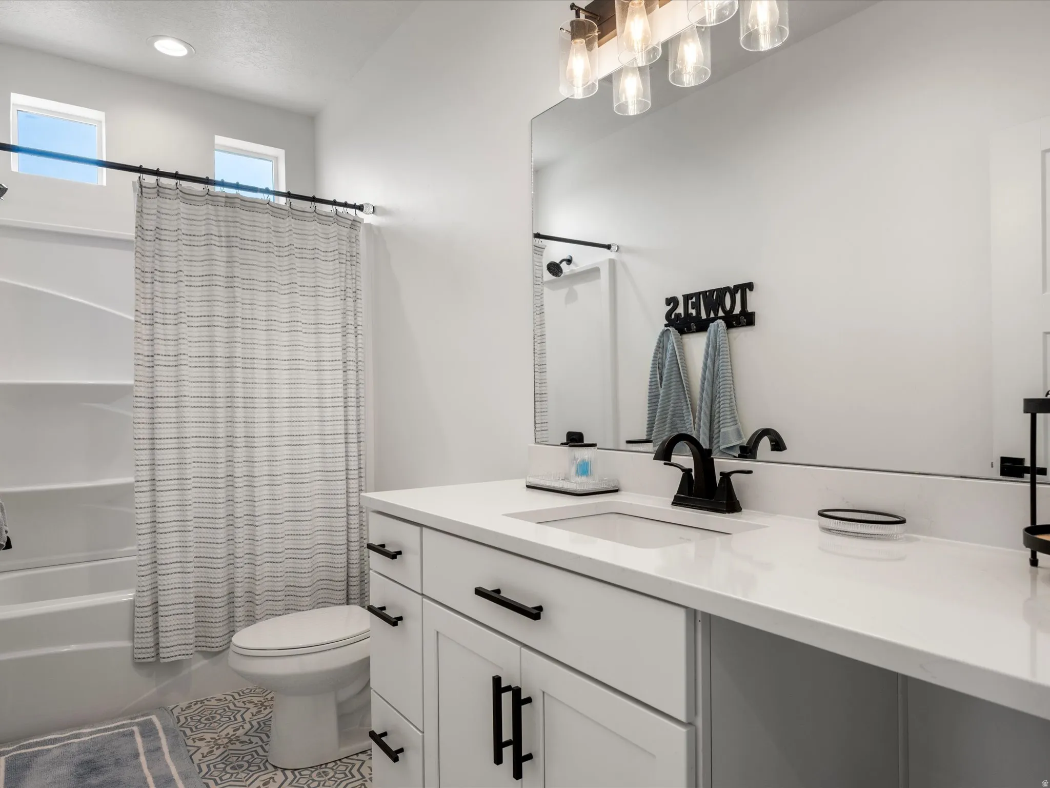 Bathroom with vanity, shower / bath combo with shower curtain, tile patterned floors, and recessed lighting