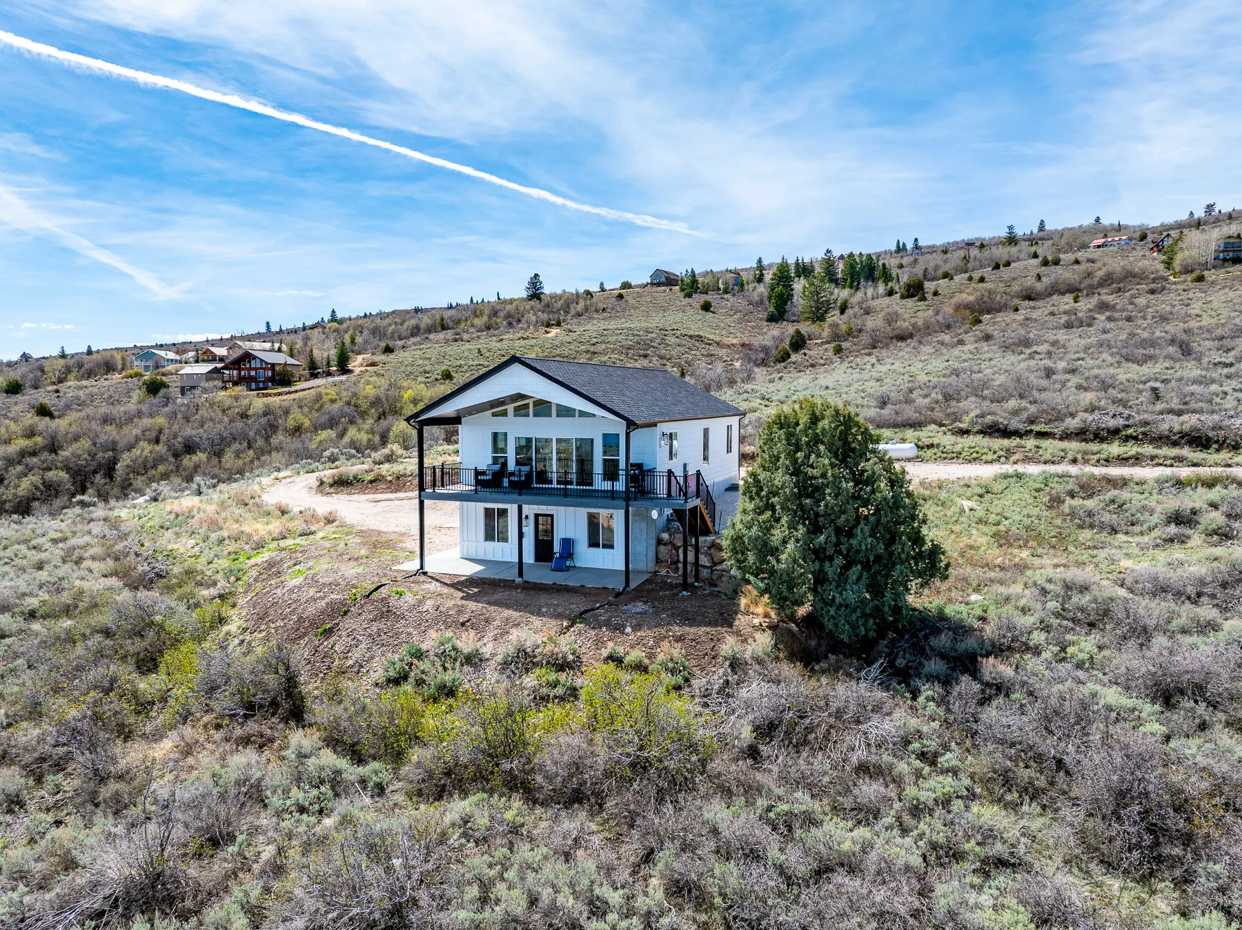 View of property with a patio area and a covered deck