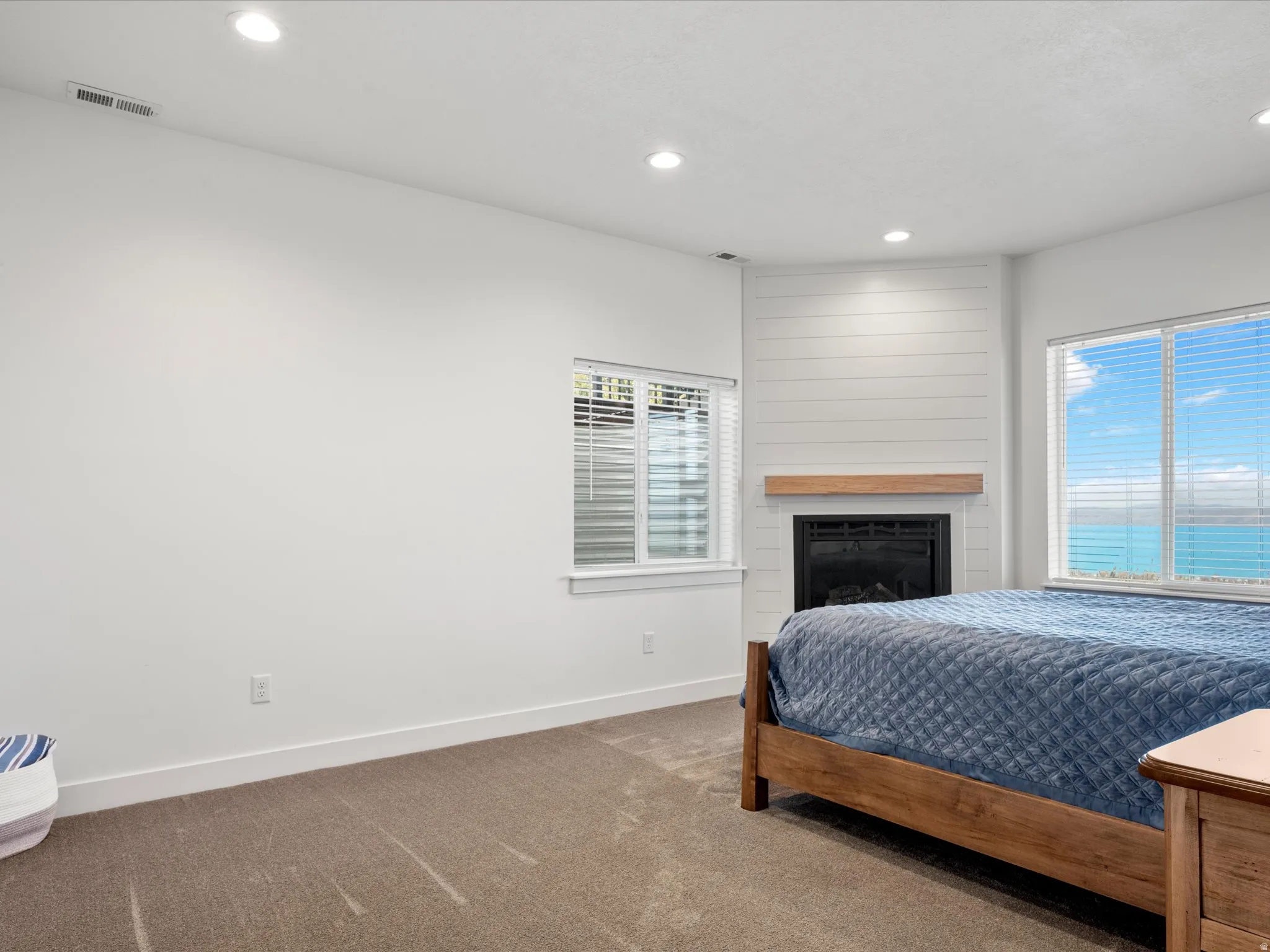 Bedroom featuring recessed lighting, carpet floors, and a fireplace