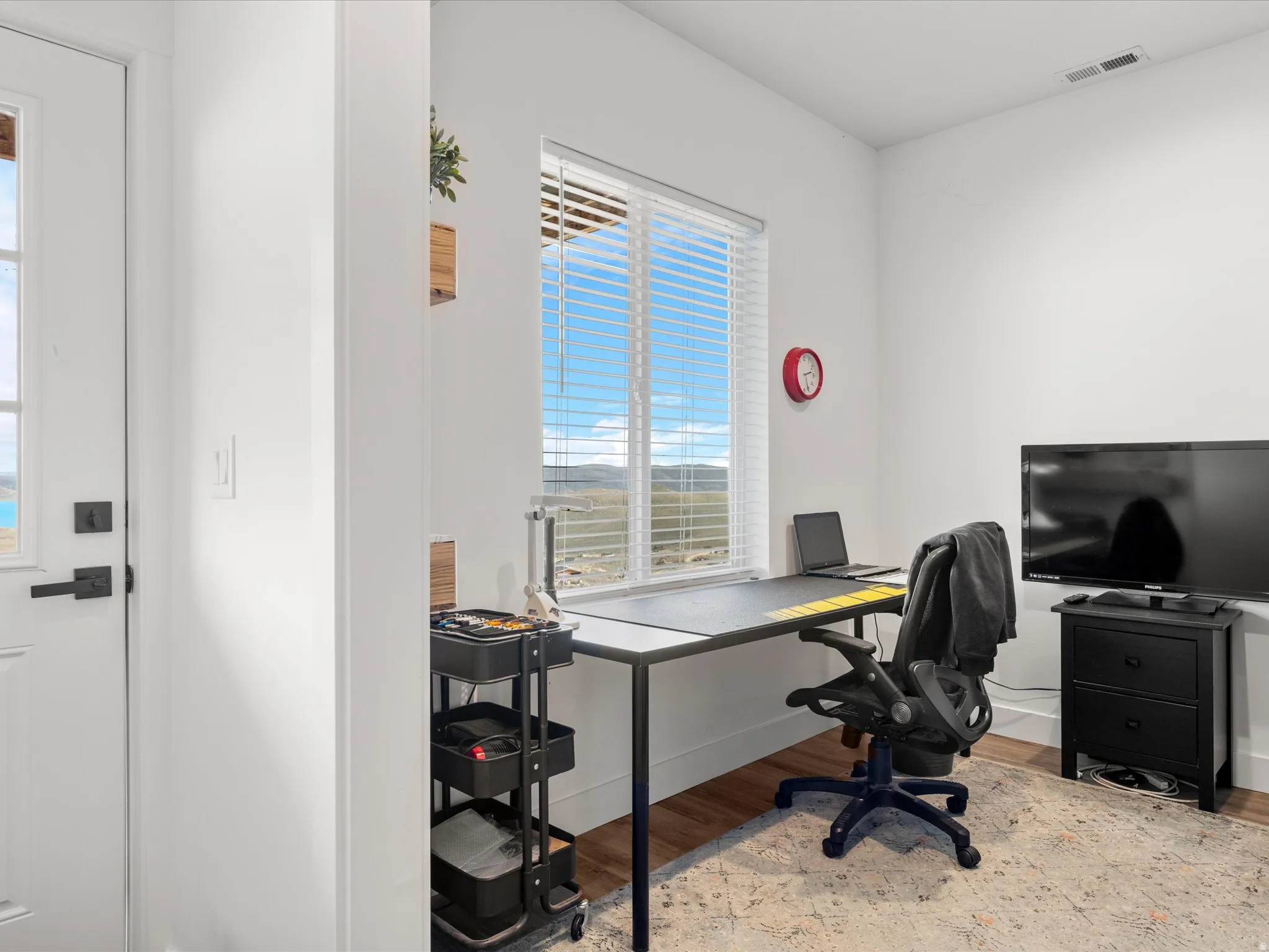 Office area featuring light wood-type flooring and baseboards
