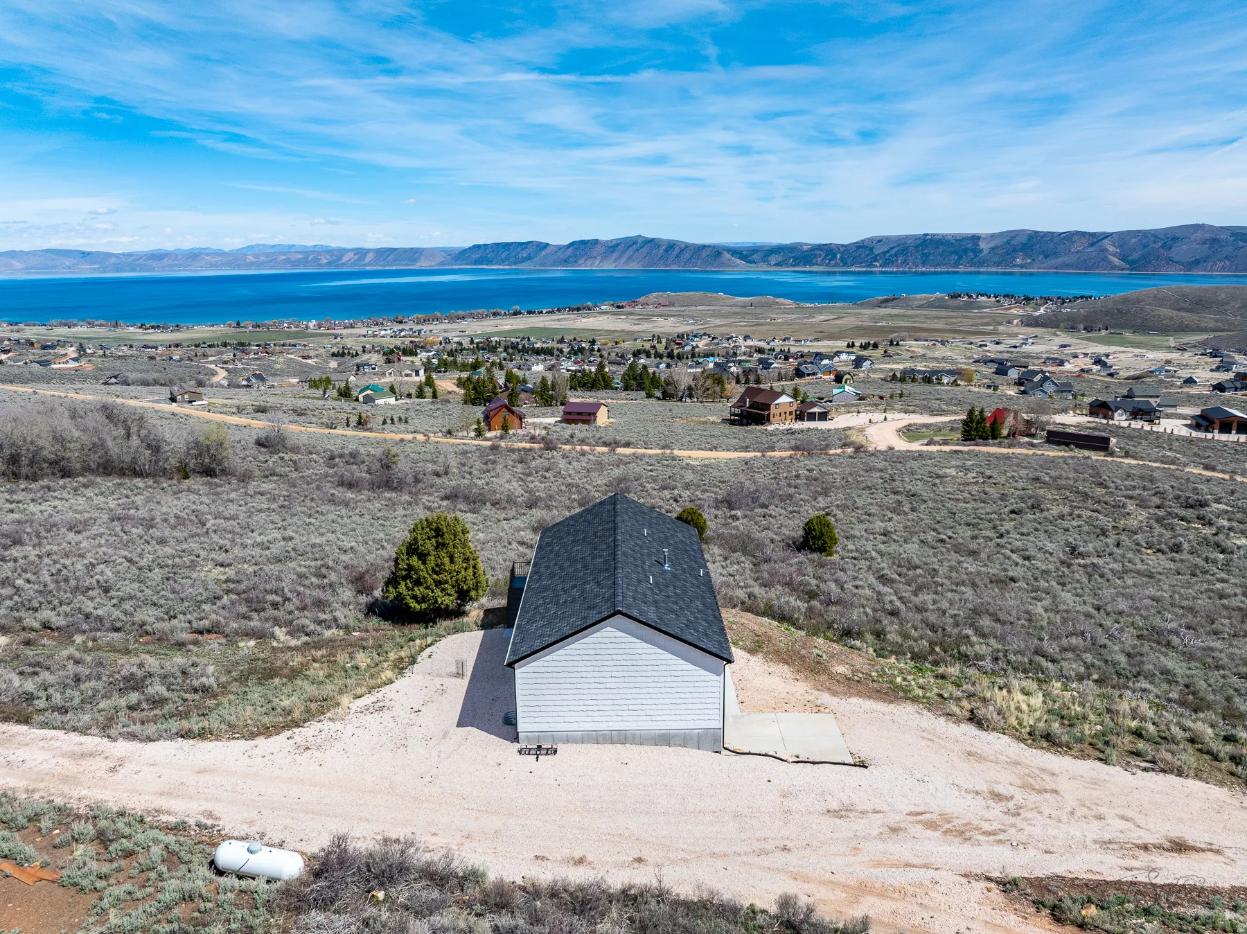 View of subject property with a water and mountain view
