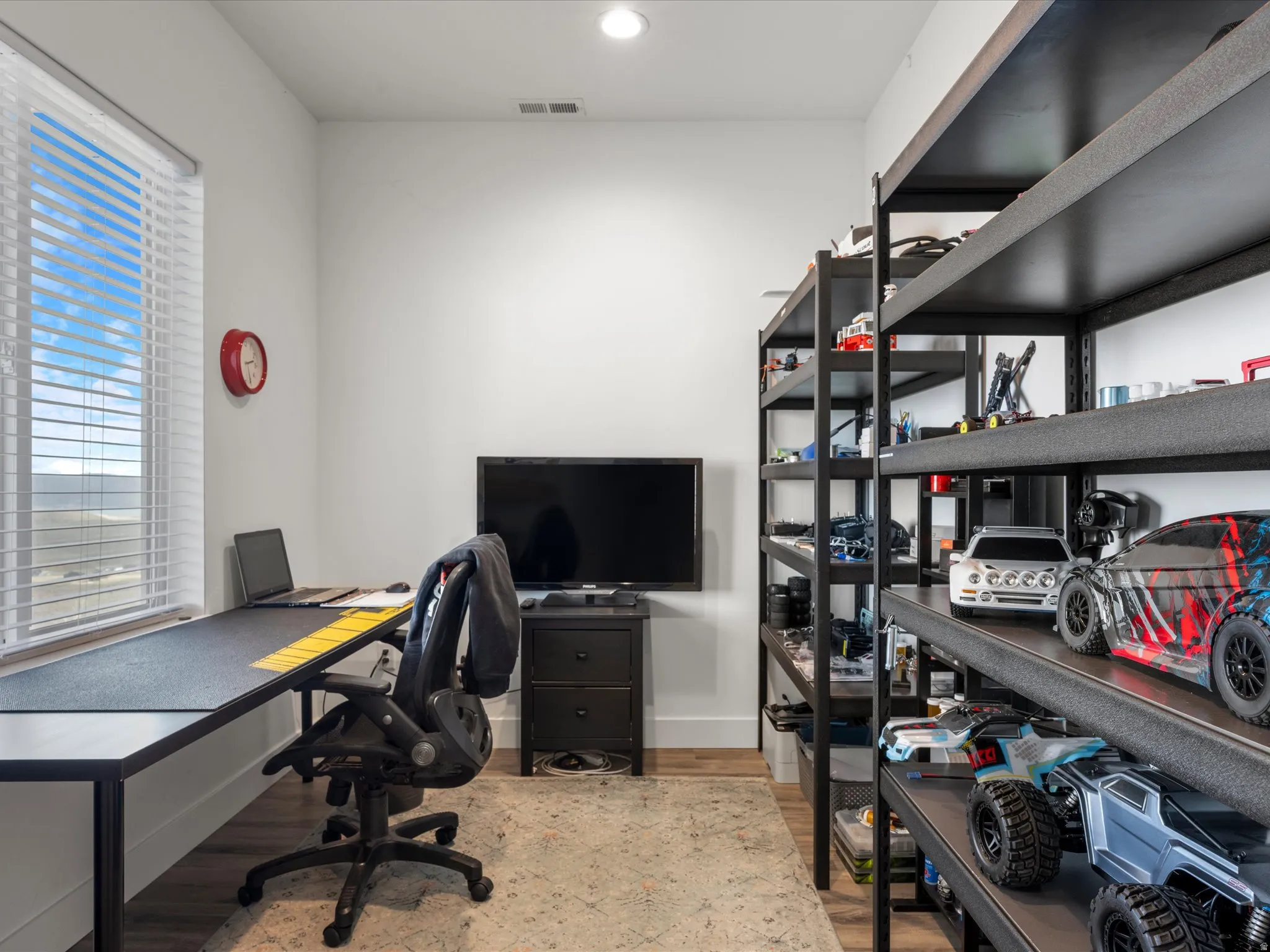Office area with light wood-type flooring and recessed lighting