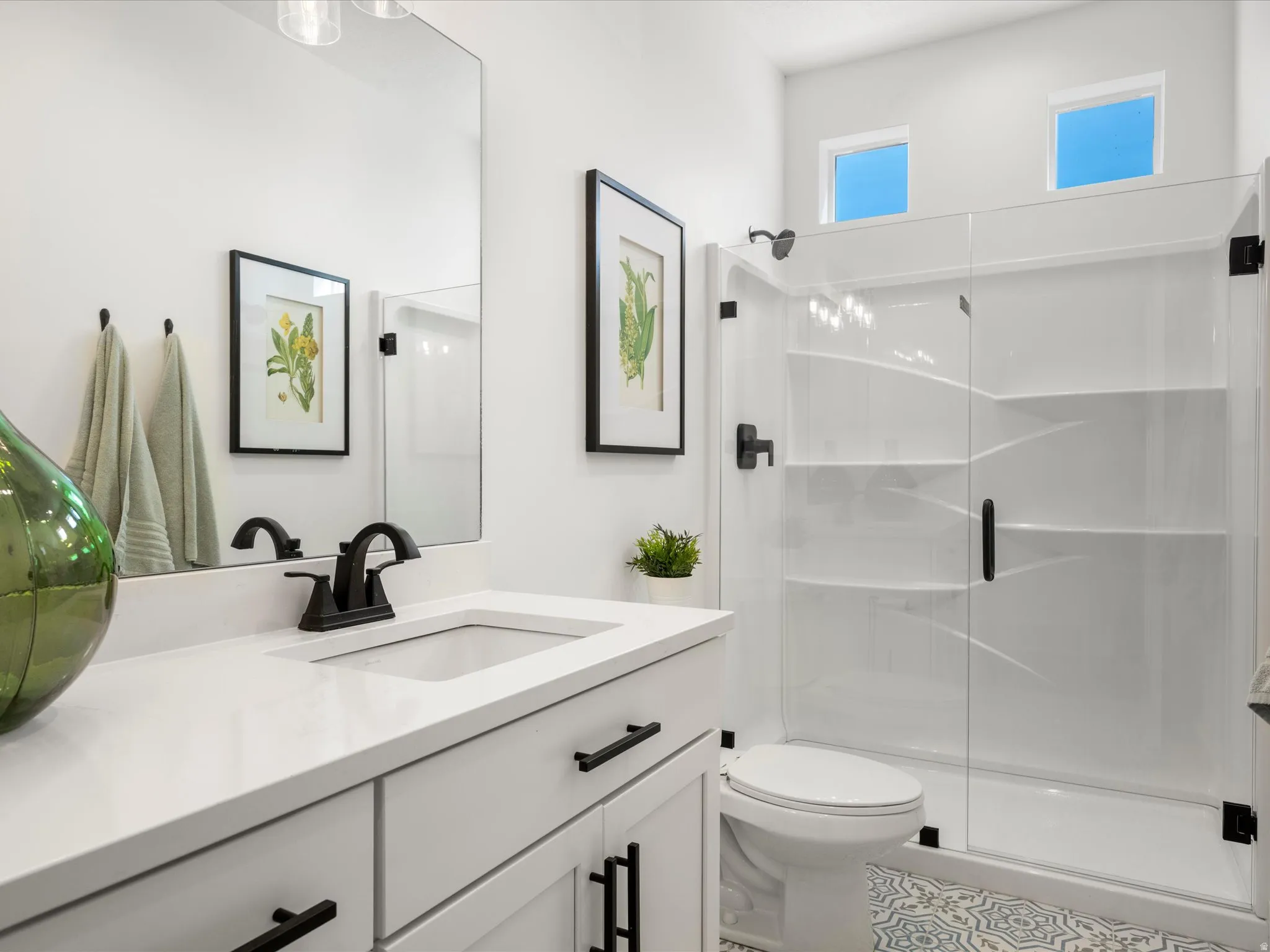 Bathroom featuring vanity and a shower stall
