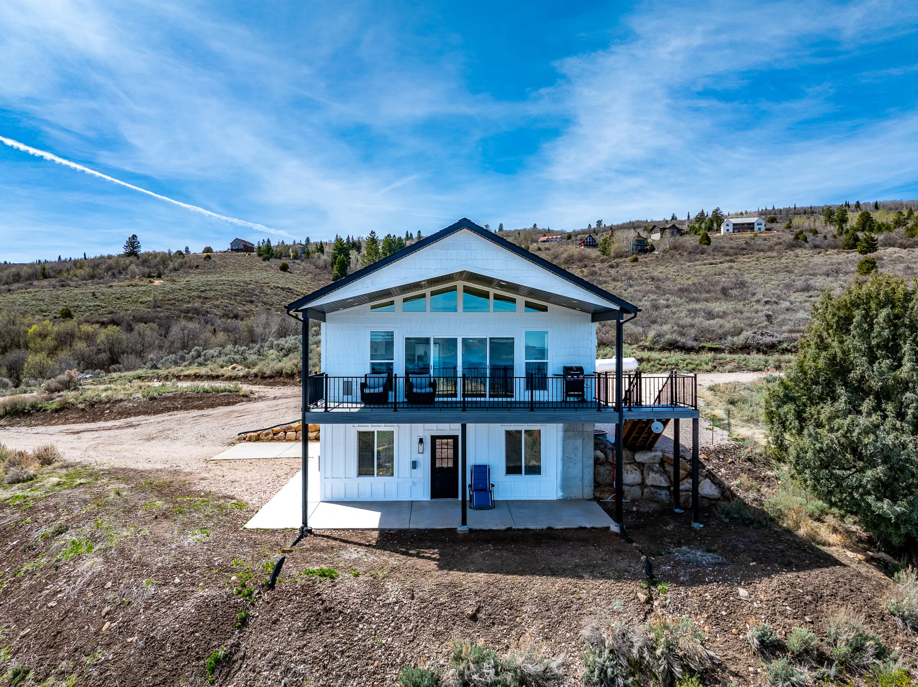 Back of property featuring a patio and a view of countryside