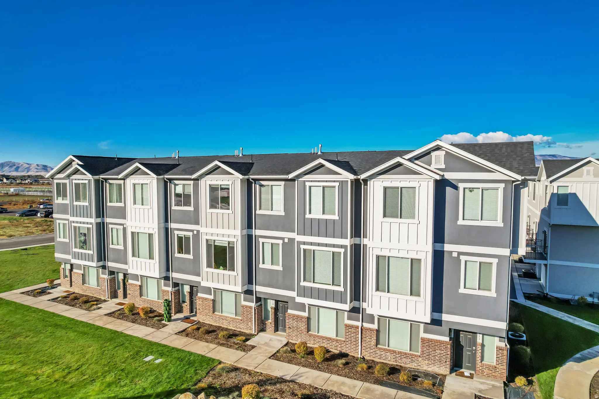 Rear view of property with residential view, a lawn, and brick siding