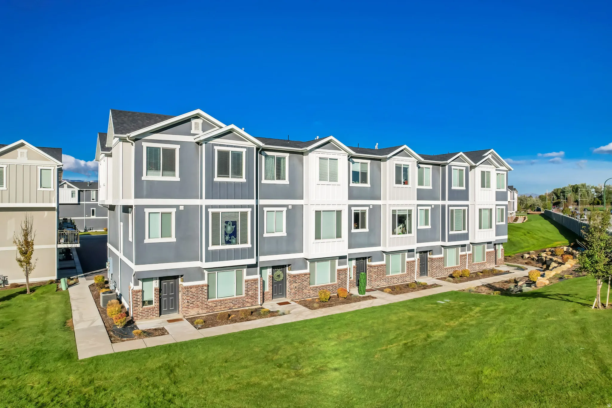 View of front of property with a residential view, board and batten siding, and brick siding
