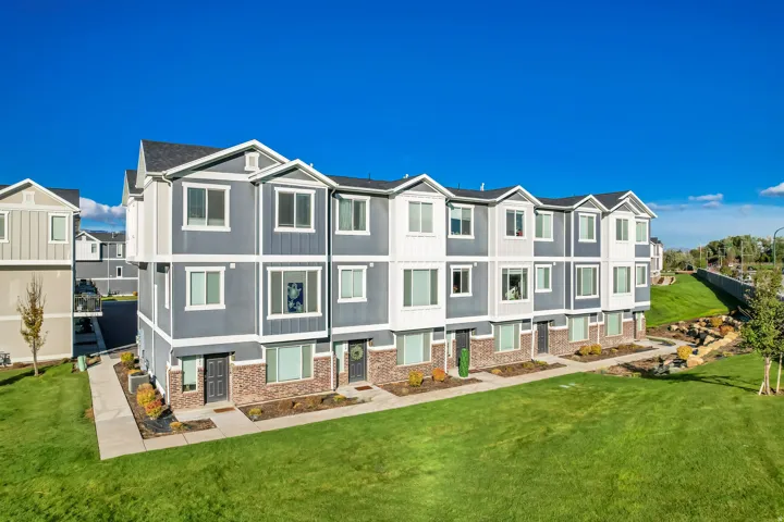 View of front of property with a residential view, board and batten siding, and brick siding