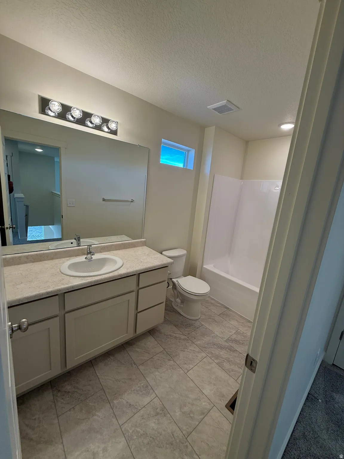 Vanity with a single basin sink, extensive countertop space, and under-cabinet storage