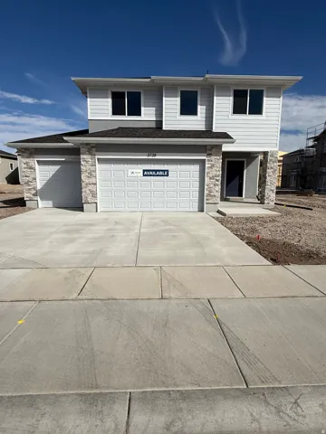 Two-story residence featuring light gray siding, dark gray trim, and stone veneer accents