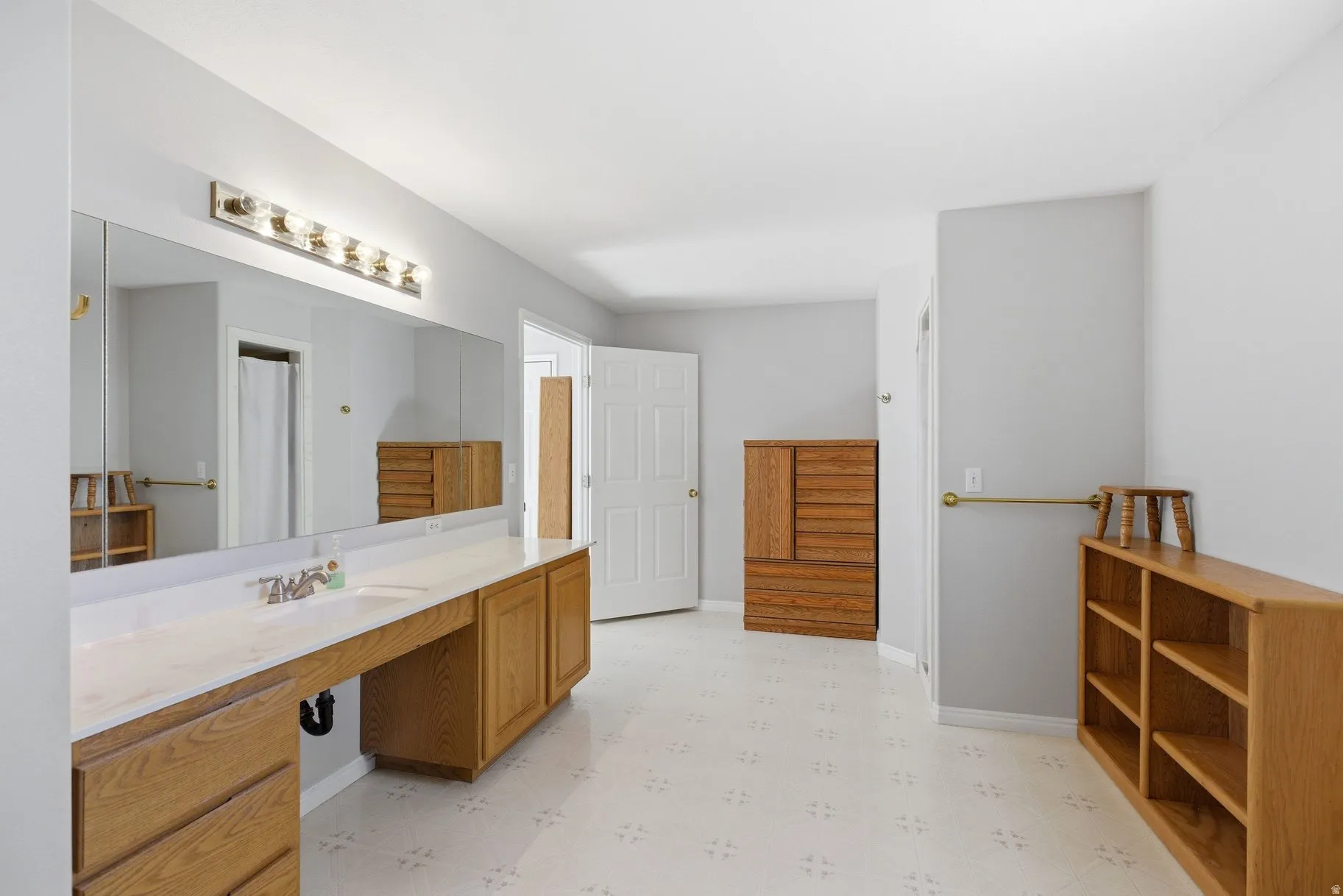 Bathroom with light floors and vanity