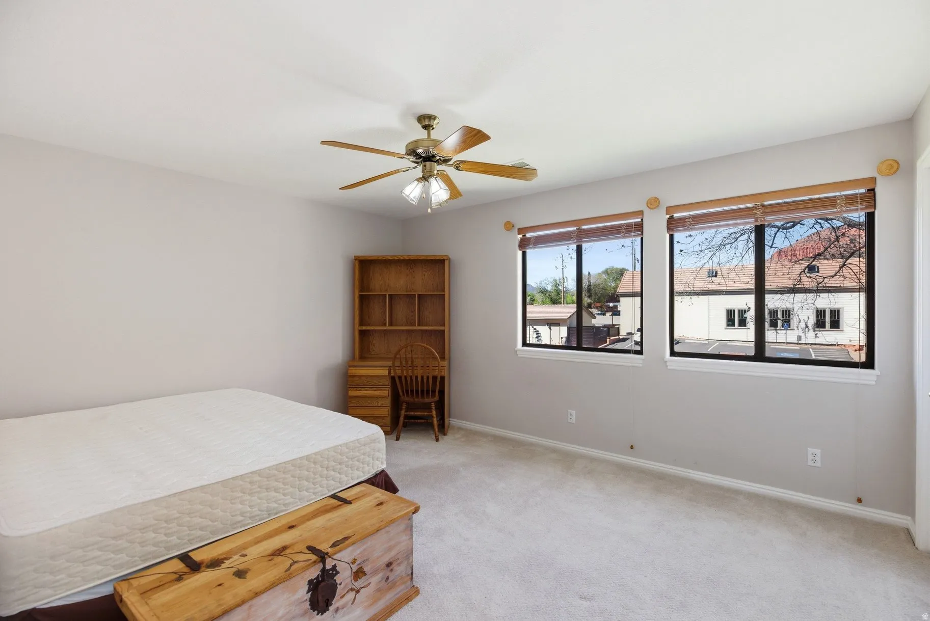 Bedroom featuring light carpet and ceiling fan