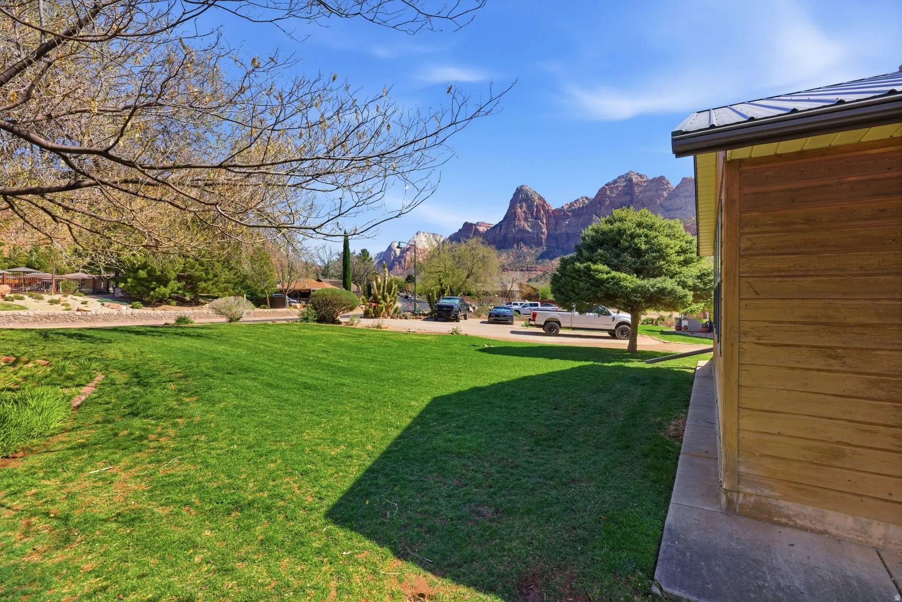 View of grassy yard with a mountain view