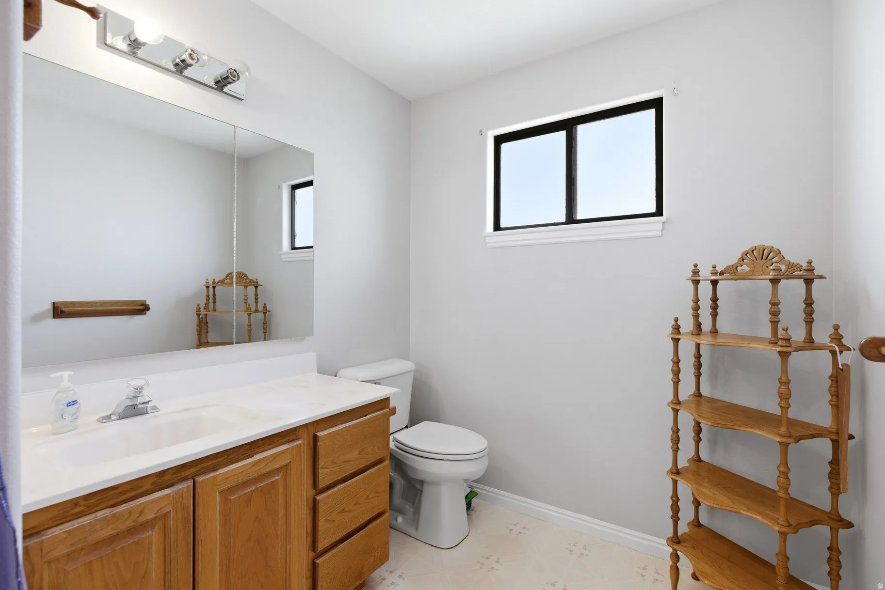 Half bath featuring vanity and light flooring