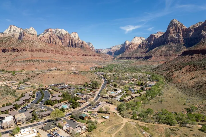 View of mountain backdrop featuring nearby suburban area