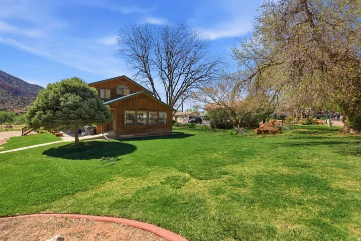 View of green lawn featuring a mountain view