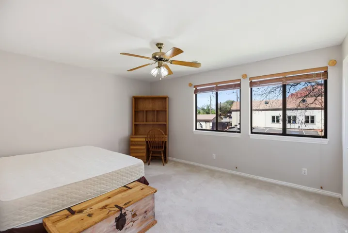 Bedroom featuring light carpet and ceiling fan