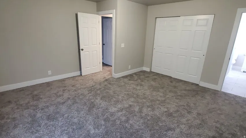 Unfurnished bedroom with carpet and a closet