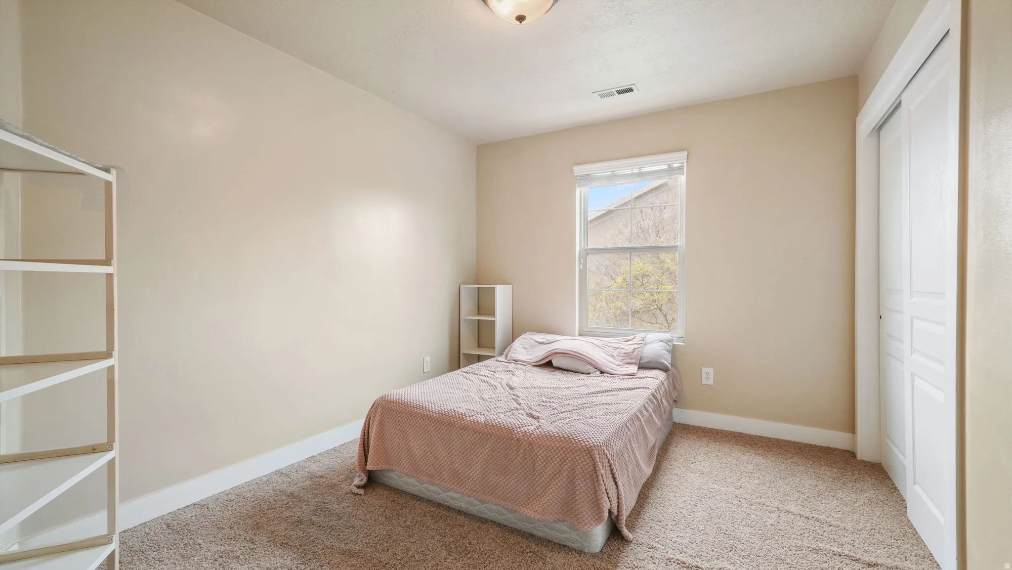 Bedroom with carpet floors and a closet