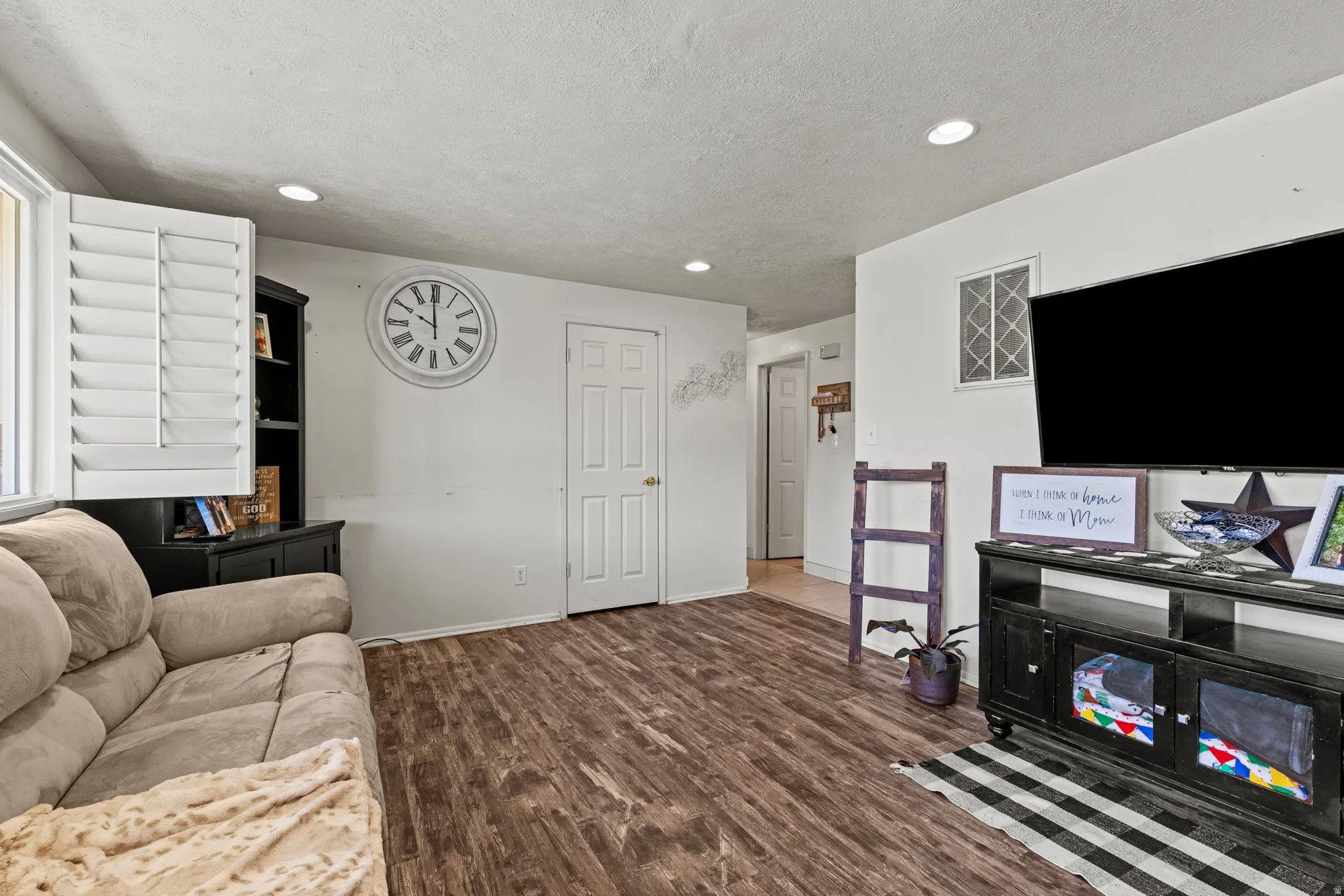 #815 with new LVT, recessed lighting, and a textured ceiling.
