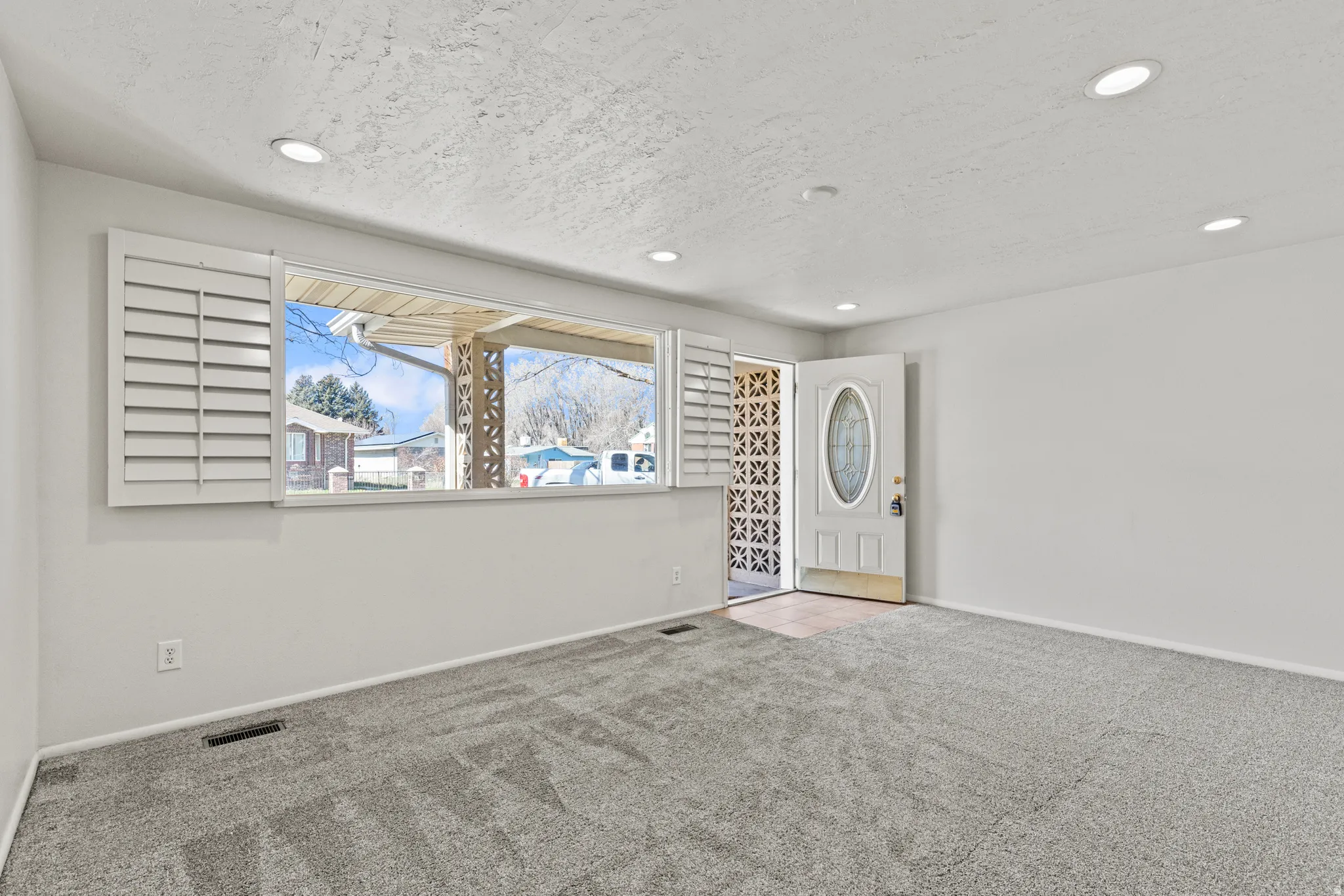 #813 Family room; Newer windows, shutters and updated lighting.