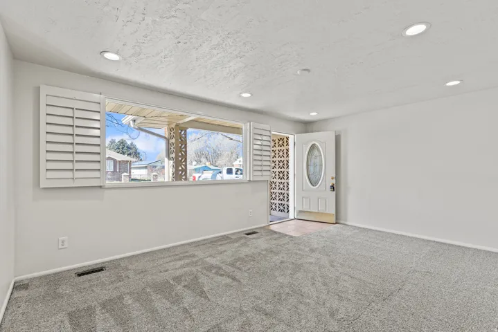 #813 Family room; Newer windows, shutters and updated lighting.