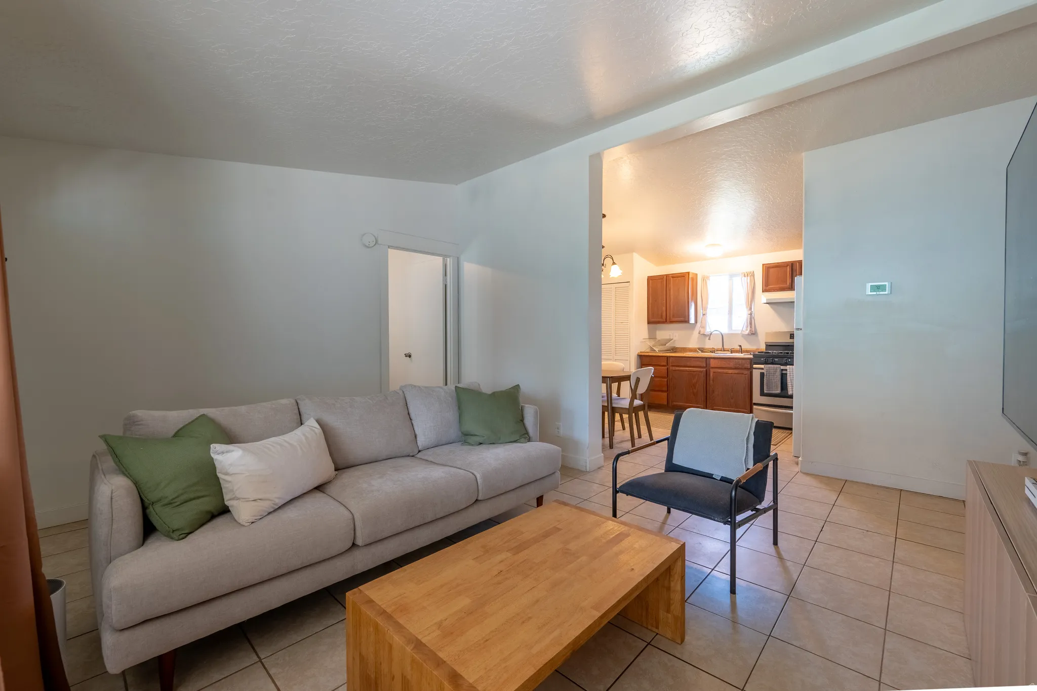 Living room featuring light tile patterned floors and baseboards