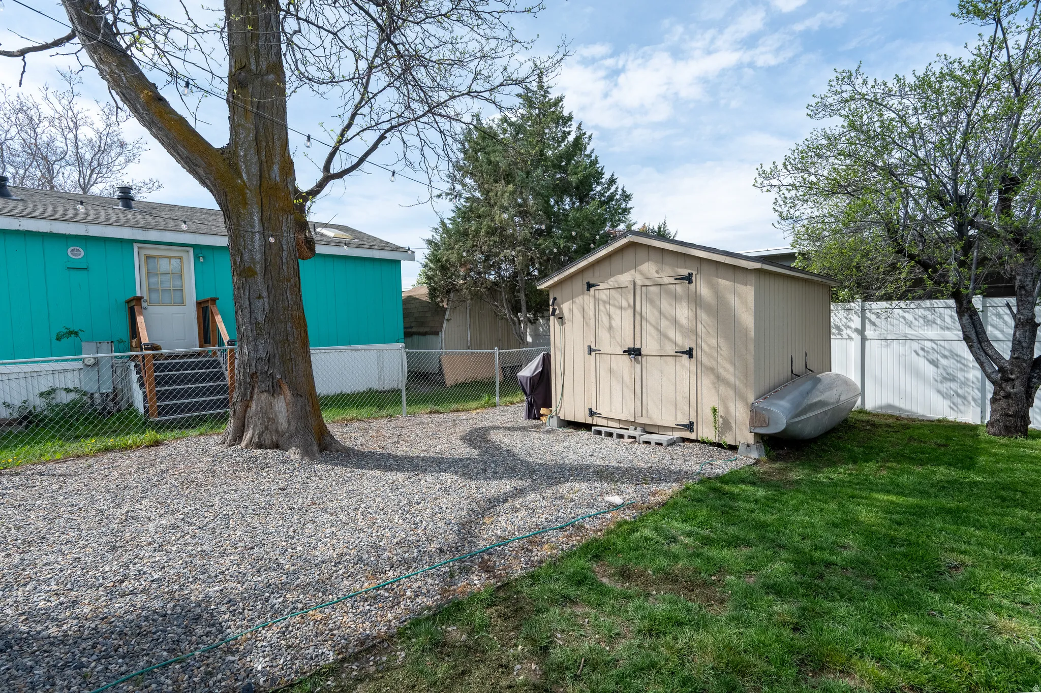 Fenced backyard with a storage unit