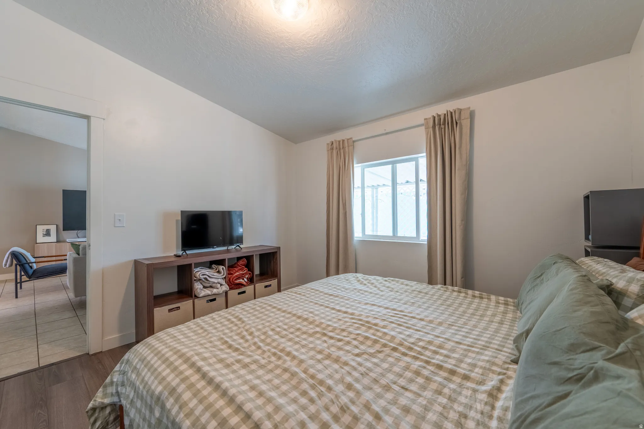 Bedroom featuring wood finished floors and baseboards