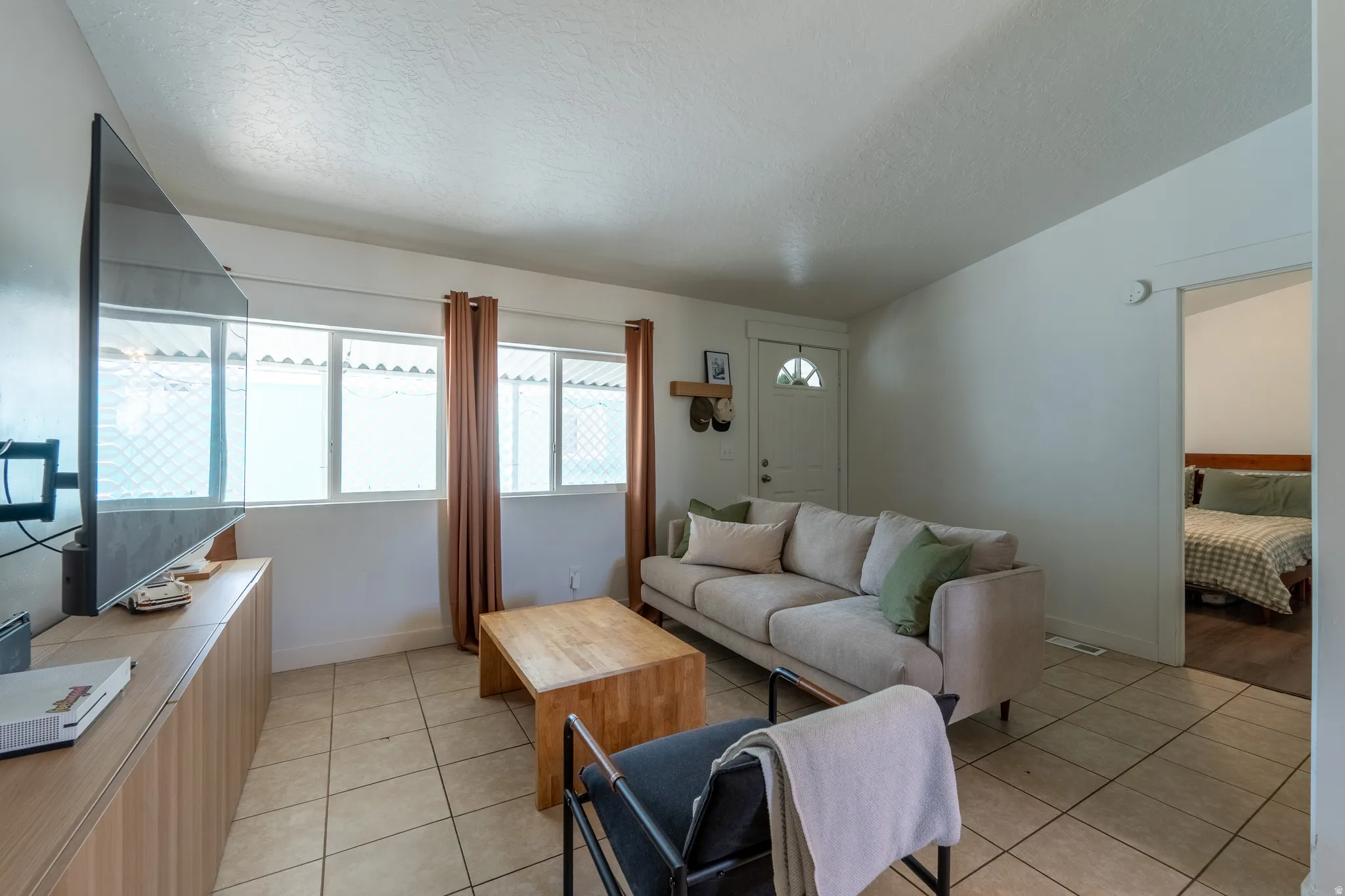 Living area with light tile patterned floors and baseboards