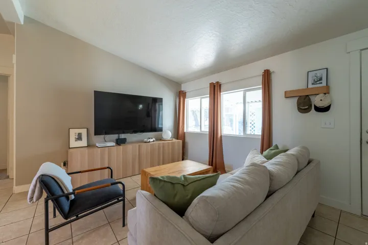 Living room featuring light tile patterned floors and baseboards
