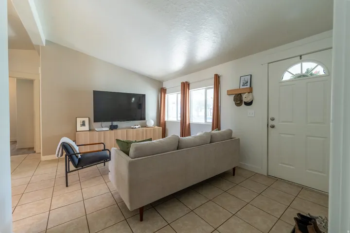 Living area with light tile patterned floors and baseboards
