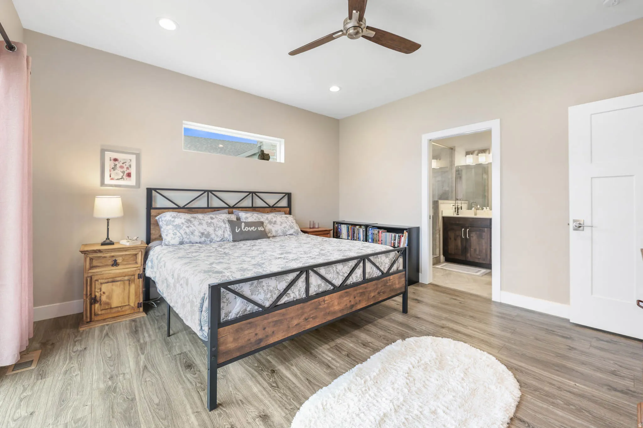 Bedroom with light wood-style flooring, a ceiling fan, recessed lighting, and ensuite bath