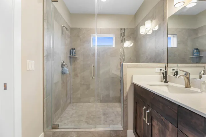 Full bath with vanity and a shower stall