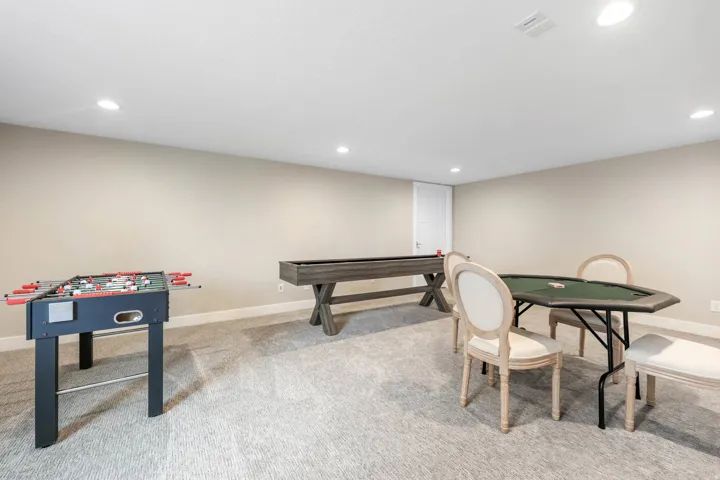 Recreation room featuring light colored carpet and recessed lighting